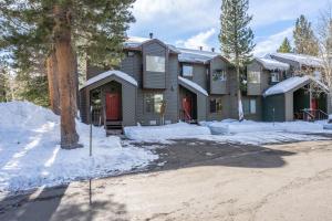 a house with red doors in the snow at 2 bedroom 3 bath in Forest Creek 35 sleeps 5 Just steps to free town shuttle Great Views in Mammoth Lakes