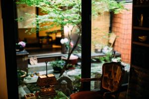 a view of a garden from a window with a chair at Tsukito in Kyoto