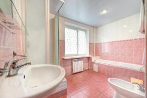 a pink bathroom with a sink and a tub at Holosiyvsky Hotel in Kyiv