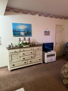 a living room with a large wooden dresser at River Place Condos #110 3BD in Pigeon Forge