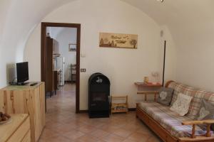 a living room with a couch and a fireplace at Apartments Carisolo - Val Rendena in Carisolo