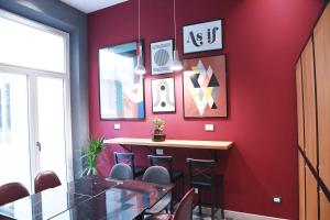 a red wall with a bar in a restaurant at Ricasoli Boutique in Florence +39 photos
