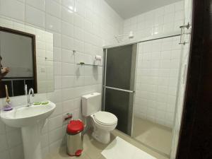 a bathroom with a shower and a toilet and a sink at Hotel SALINE PRAIA in Salinópolis