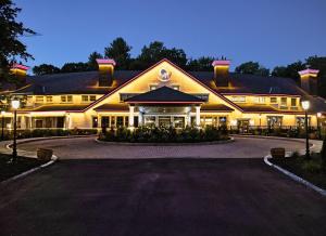a large building with a driveway in front of it at Chateau Merrimack Hotel & Spa in Tyngsboro