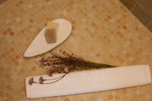 a table with a cutting board and a piece of cheese and herbs at My Rooms Ciutadella Adults Only by My Rooms Hotels in Ciutadella