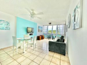 a living room with a table and a couch at Blue Marine Apartment in Fajardo