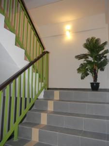 a staircase with a potted plant on the wall at Hotel Wawasan in Simpang Renggam