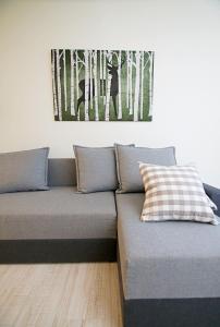 a couch in a room with a picture on the wall at Willa Pod Lasem in Jastrzębia Góra