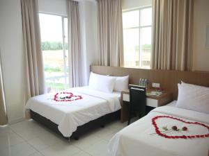 Postel nebo postele na pokoji v ubytování Hotel Wawasan