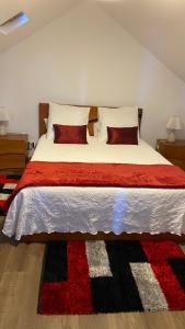 a bedroom with a large bed with two pillows at Cozy 1 BR w/ balcony, ocean view & perfect sunsets in Ribeira Brava