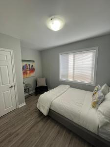 a bedroom with a large bed and a window at Casa LACK - Tranquila Suites 2 in Ottawa