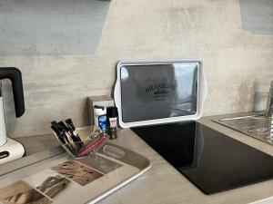 a kitchen counter with a sink and a tv on it at Studio Meublé in Bussy-Saint-Georges