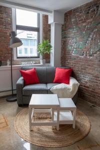 a living room with a couch and a brick wall at Cameo Hotel and Suites in Halifax