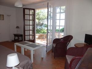 a living room with a couch and a table at Villa climatisée 2 chambres avec terrasse et garage - FR-1-100-199 in Cavalaire-sur-Mer