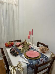 a dining room table with a christmas table cloth and a tableablish at Frida in Viareggio