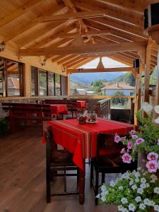 a dining room with a table with a red table cloth at Kovacha Guest House in Raduil