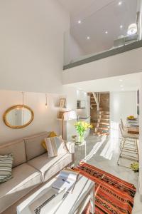 a living room with a couch and a table at Loft duplex Sevilla wall in Seville