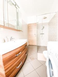 a bathroom with a sink and a shower and a toilet at Apartment #Story in Koper