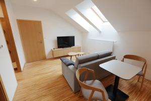 a living room with a couch and a table at Apartmány U Květné zahrady in Kroměříž