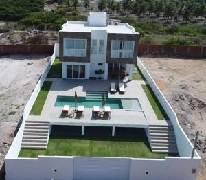 an aerial view of a house with a swimming pool at PIPA Magnifique villa moderne en front de mer in Tibau do Sul