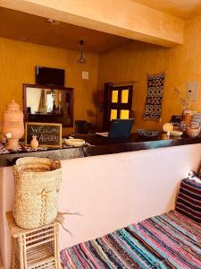 a kitchen with a counter with a laptop on it at Aghurmi Siwa Ecolodge & Salt Cave in Siwa