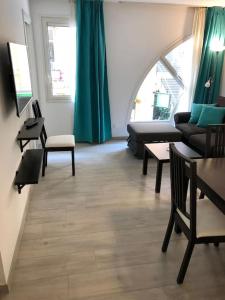 a living room with a couch and a table at Monaco Beausoleil "La maison de Marie" in Beausoleil +11 photos