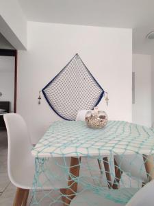 uma mesa e uma cadeira com um cesto em Apartamento Coral em Santa Maria