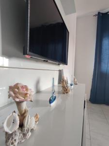 um balcão branco com uma televisão em cima em Apartamento Coral em Santa Maria