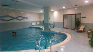 a person in a swimming pool in a building at Apartments Flora-Daisy in Borovets