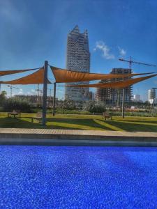 a canopy over a swimming pool in a city at A 2 minutes de Casa Finance City, appartement avec 2 Chambres in Casablanca