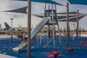 a playground with a slide in a park at A 2 minutes de Casa Finance City, appartement avec 2 Chambres in Casablanca