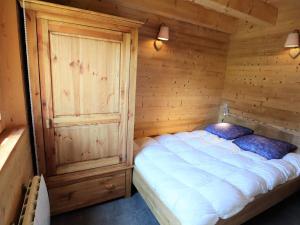 a bedroom with a bed in a wooden room at Chalet Arêches-Beaufort, 4 pièces, 8 personnes - FR-1-342-208 in Beaufort