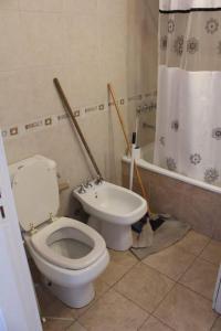 a bathroom with a toilet and a bath tub at Petit depto en mar del plata in Mar del Plata