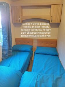 two beds in a room with a sign on the wall at Southview holiday park skegness disabled friendly in Skegness