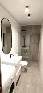 a white bathroom with a sink and a mirror at Apartamento Playa Las Americas in Playa de las Americas