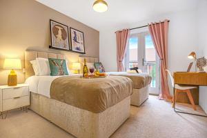 a bedroom with two beds and a desk with a desk at Middleton House with Free Parking, Fast-Wifi, SmartTV and Garden by Yoko Property in Milton Keynes
