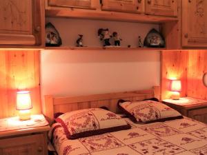 a bedroom with two beds and two lights on shelves at Appartement Vars, 2 pièces, 6 personnes - FR-1-330B-151 in Vars