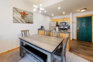 a dining room with a table and a kitchen at Tucker Mountain Lodge 307a in Copper Mountain