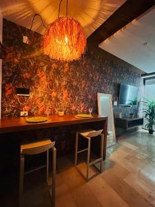 a dining room with a table and a wall at LOFT VIEW SEA The best ubication at 5th AV in Playa del Carmen
