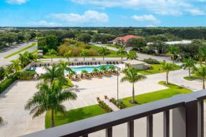 an aerial view of a resort with a pool and palm trees at Ameniti Bay - Best Western Signature Collection in Sarasota