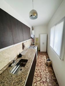 a kitchen with a sink and a counter top at San Luis Apartment in San Luis