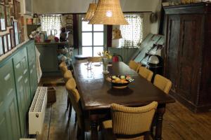 a kitchen with a wooden table with a bowl of fruit on it at Paul en Lettie's Bed and Breakfast in Westbroek