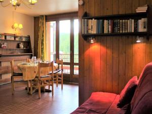 a living room with a table and a couch and a dining room at Appartement Vars, 1 pièce, 4 personnes - FR-1-330B-124 in Vars