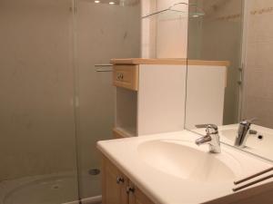 a bathroom with a sink and a shower with a mirror at Appartement Vars, 1 pièce, 4 personnes - FR-1-330B-124 in Vars