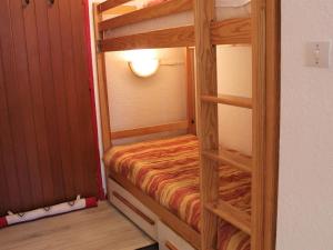 a wooden bunk bed with a ladder in a room at Appartement Vars, 1 pièce, 4 personnes - FR-1-330B-122 in Vars