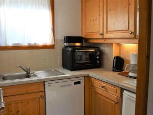 a small kitchen with a microwave and a sink at Appartement Vars, 5 pièces, 10 personnes - FR-1-330B-139 in Vars