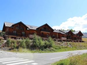 a large wooden house on the side of a road at Appartement Vars, 5 pièces, 10 personnes - FR-1-330B-139 in Vars