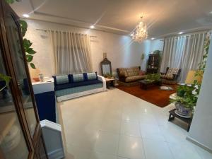 a living room with a blue couch and chairs at Central 2-bedrooms w/ balcony@Downtown Mers Sultan in Casablanca
