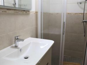 a bathroom with a sink and a shower at Appartement Vars, 1 pièce, 4 personnes - FR-1-330B-134 in Vars