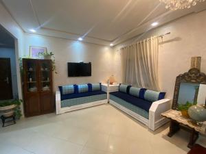 a living room with two couches and a tv at Central 2-bedrooms w/ balcony@Downtown Mers Sultan in Casablanca